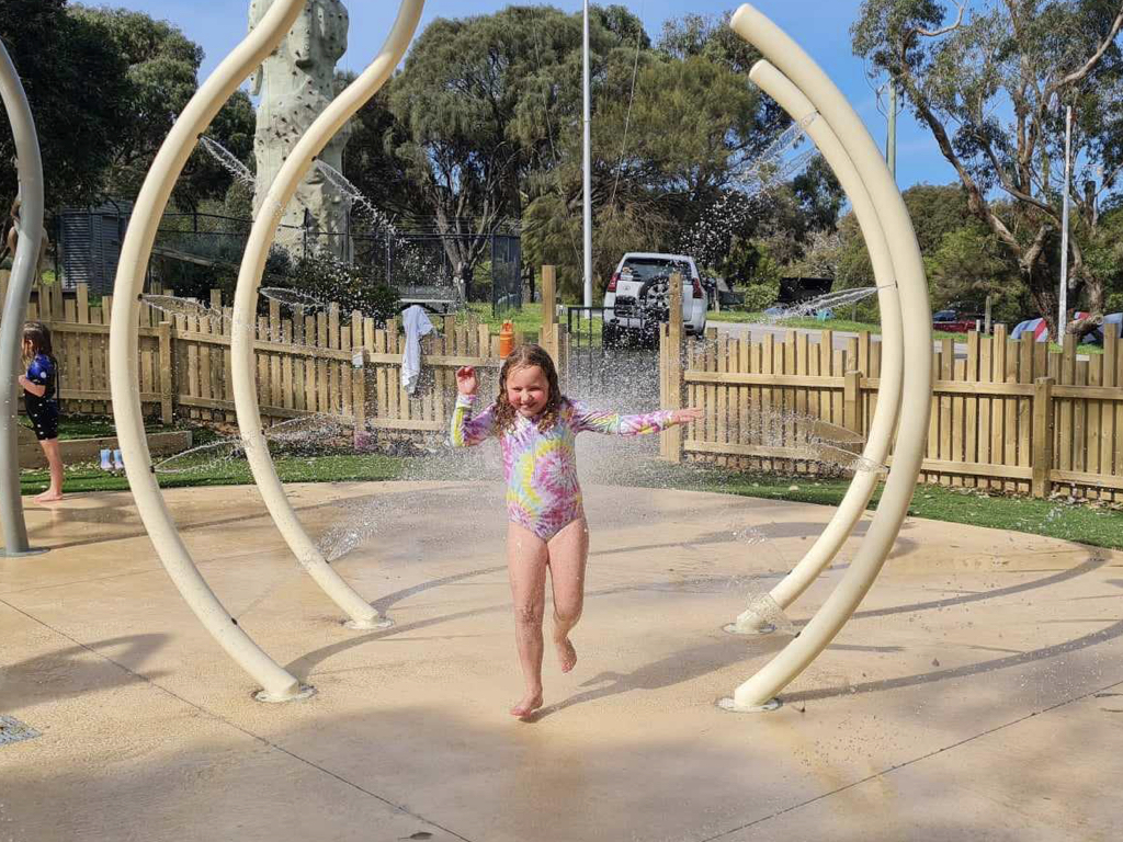 Family enjoying summer fun at splash park