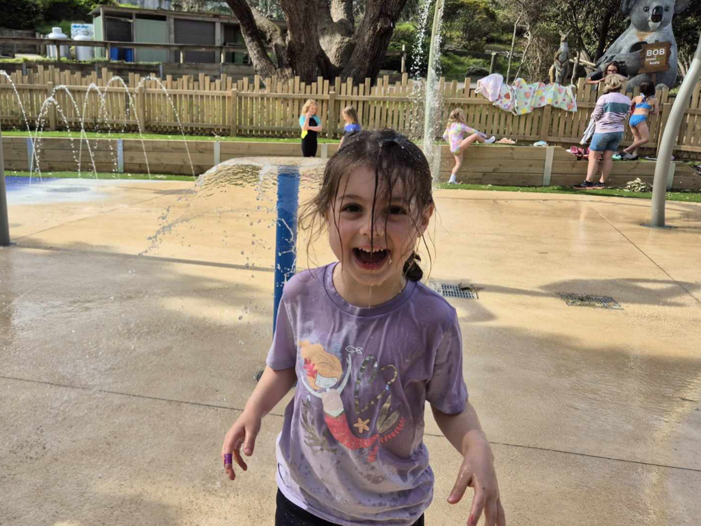 Kids having fun in the splash park fountains