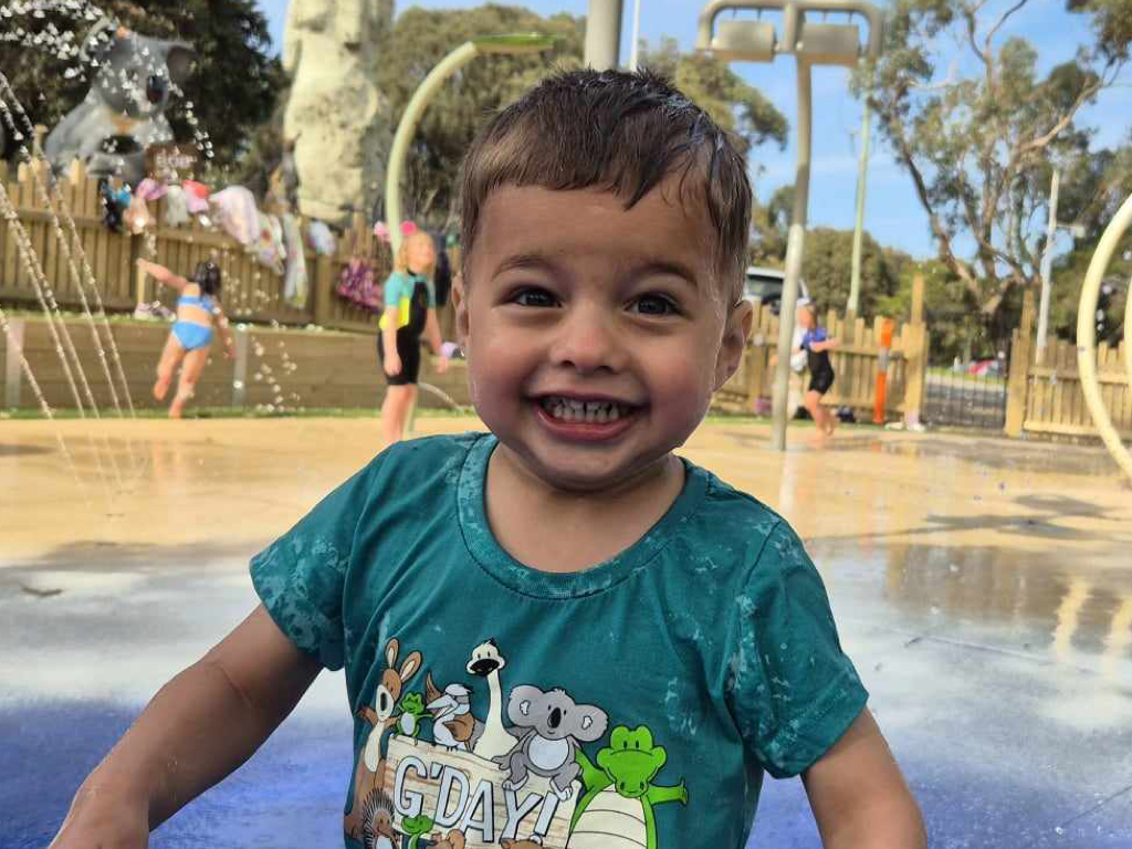 Toddler playing in water at splash park